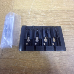 Black top-loading bridge for four-string bass